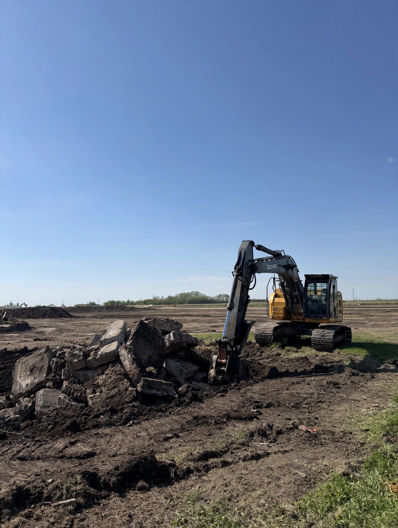 Excavator with shear attachment on site