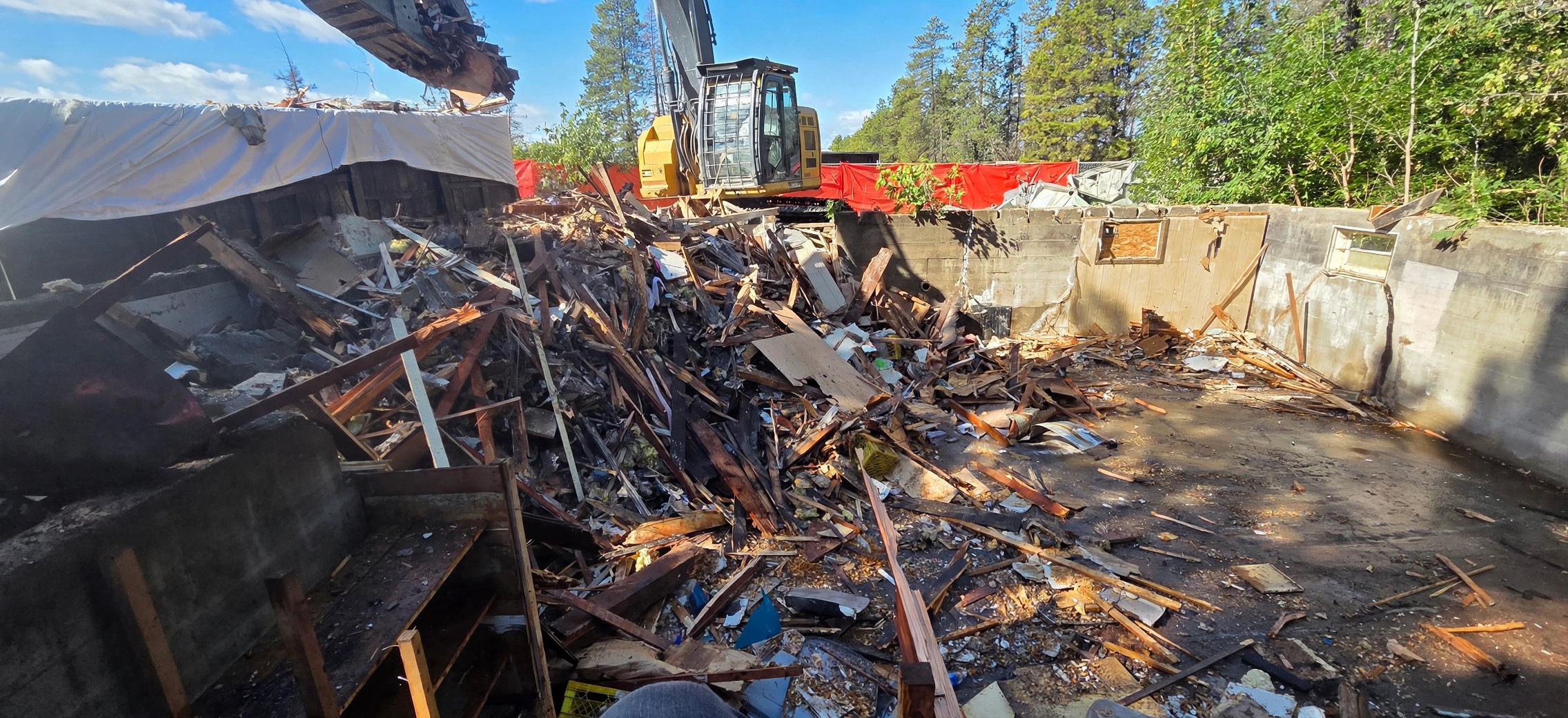 Excavator tearing down a structure